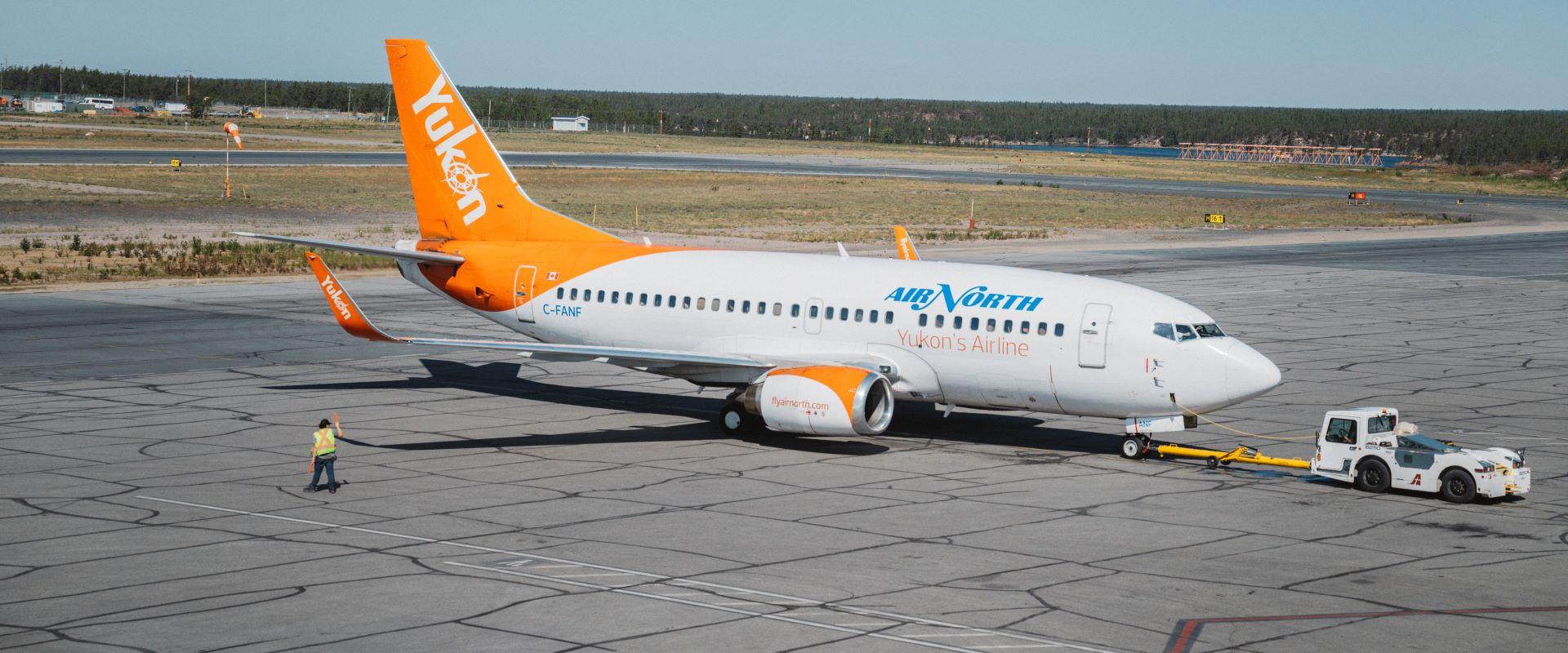 Image shows an aircraft being pushed back from the gate.